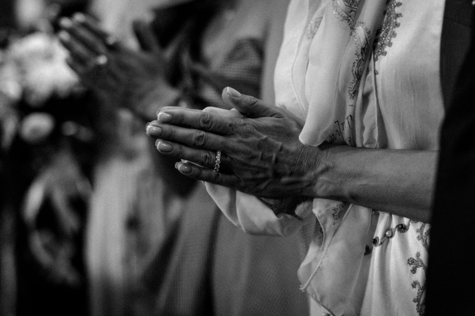 Hands folded respectfully during a memorial service
